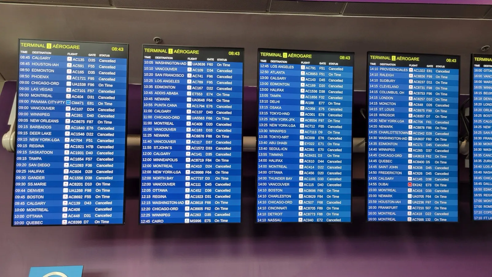 An airport departure board showing rows of cancelled flights