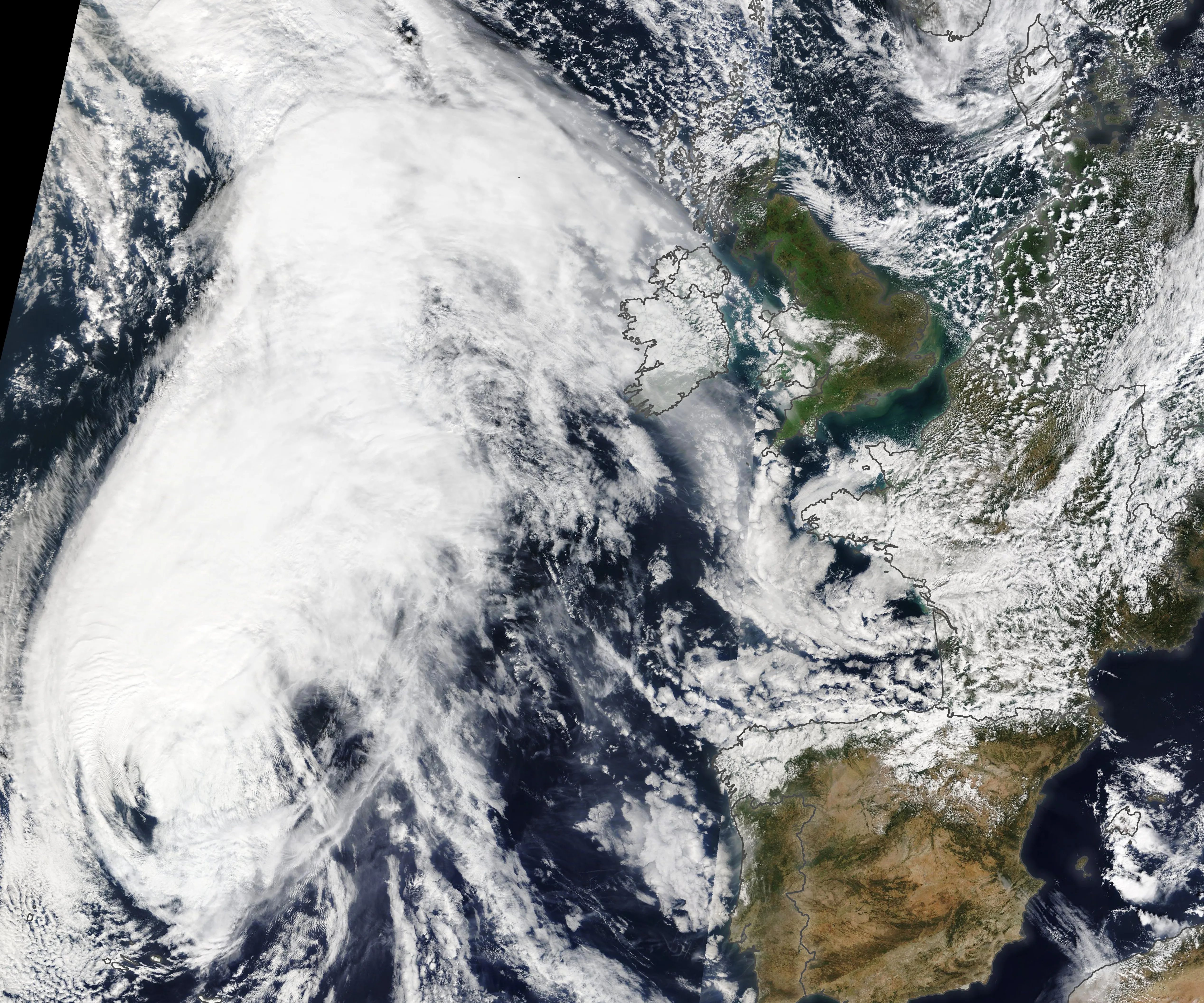 A hurricane with a large, sharply defined circular eye at its center, seen from space