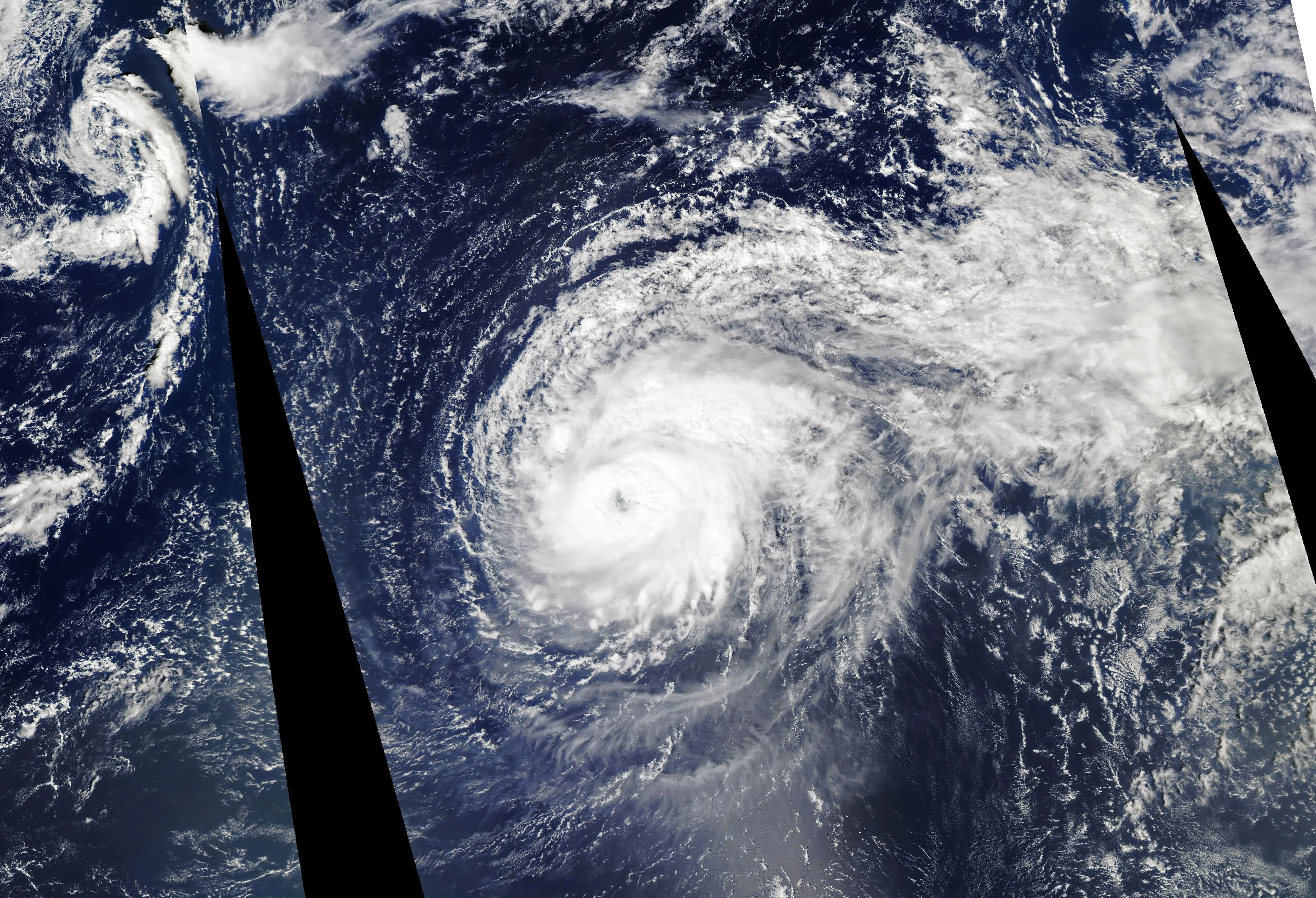 A very large hurricane whose cloud shield sprawls across a vast area of open ocean