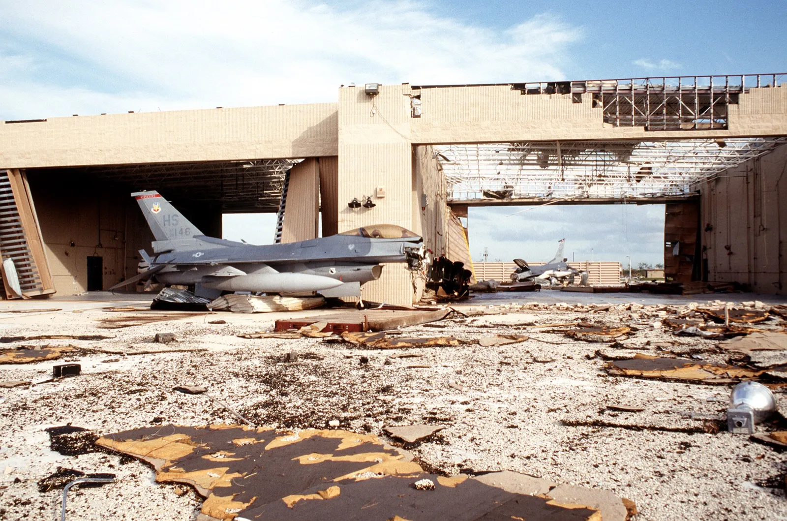 F-16 fighter jets in hangars stripped open by Hurricane Andrew at Homestead Air Force Base
