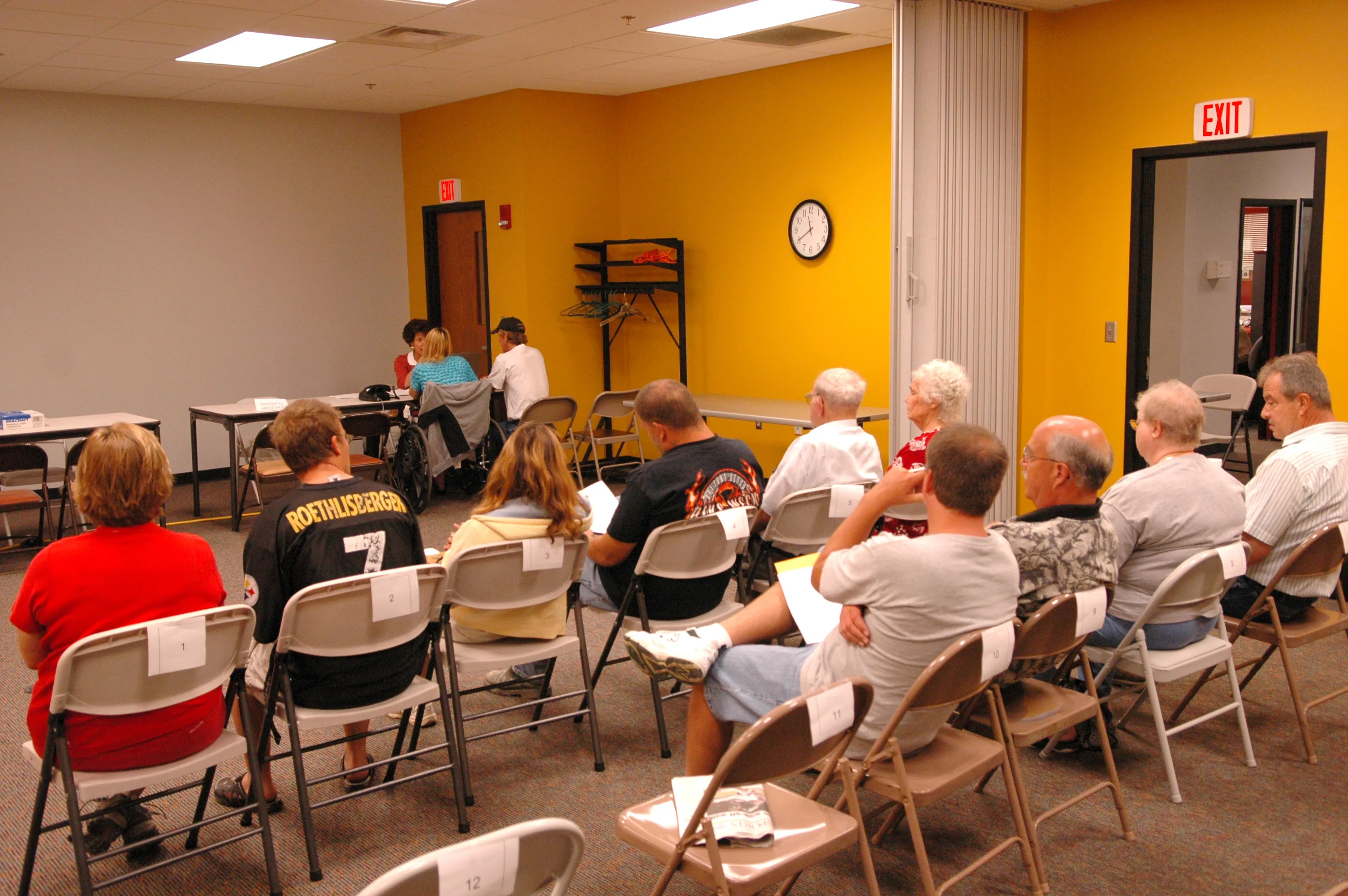 Residents wait to meet with disaster-assistance staff inside a recovery center