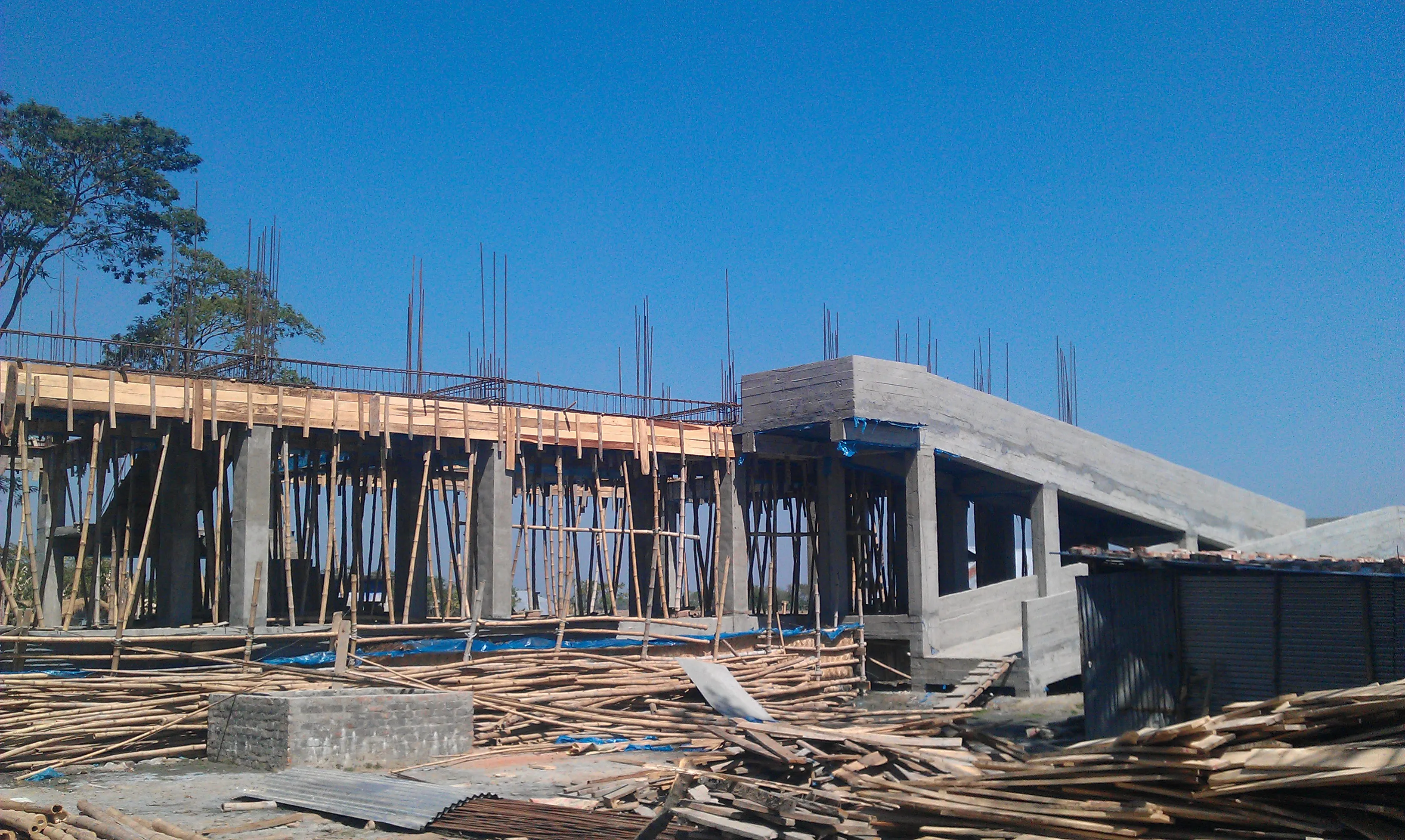 A raised concrete cyclone shelter under construction on stilts in coastal Bangladesh