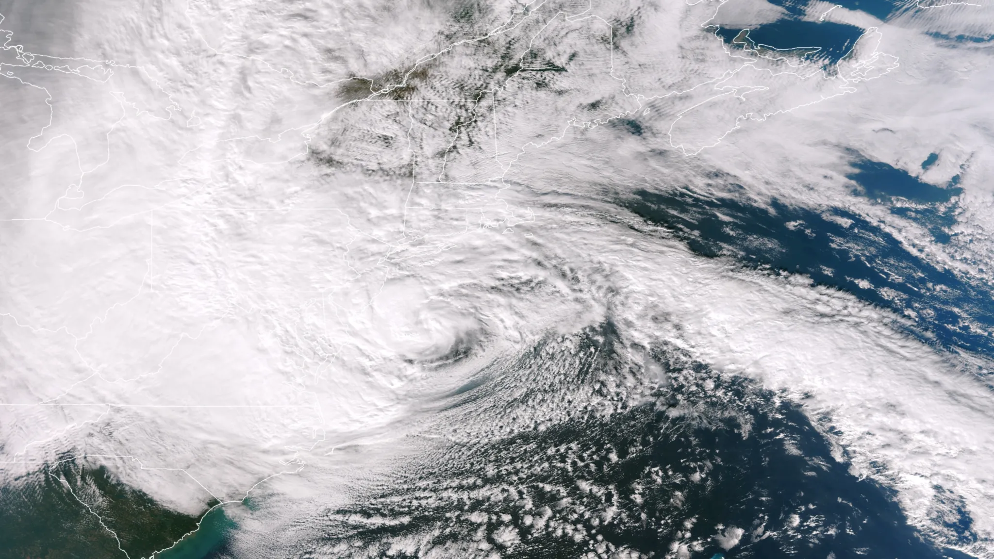 A vast hybrid storm sprawling across the U.S. East Coast as it transitions from a hurricane into an extratropical cyclone