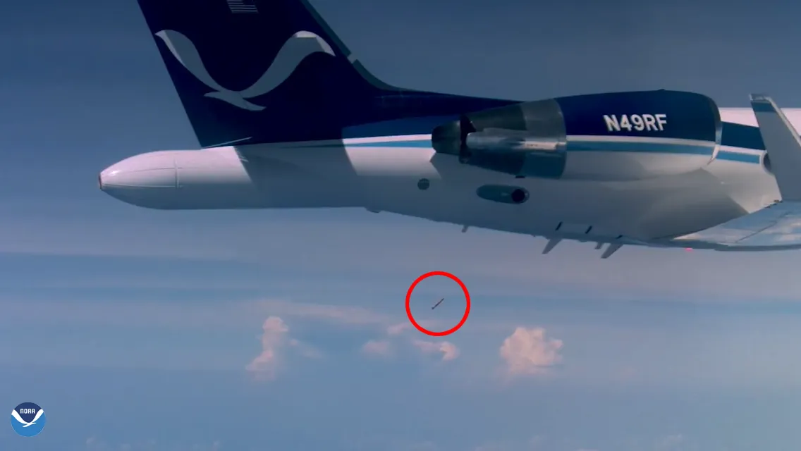A dropsonde falls away beneath the tail of NOAA's Gulfstream IV-SP jet during a hurricane surveillance flight