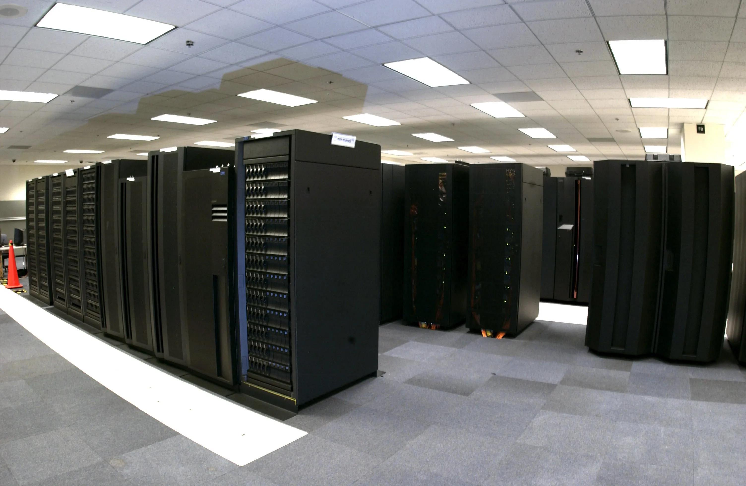 Rows of black supercomputer cabinets in a NOAA data center