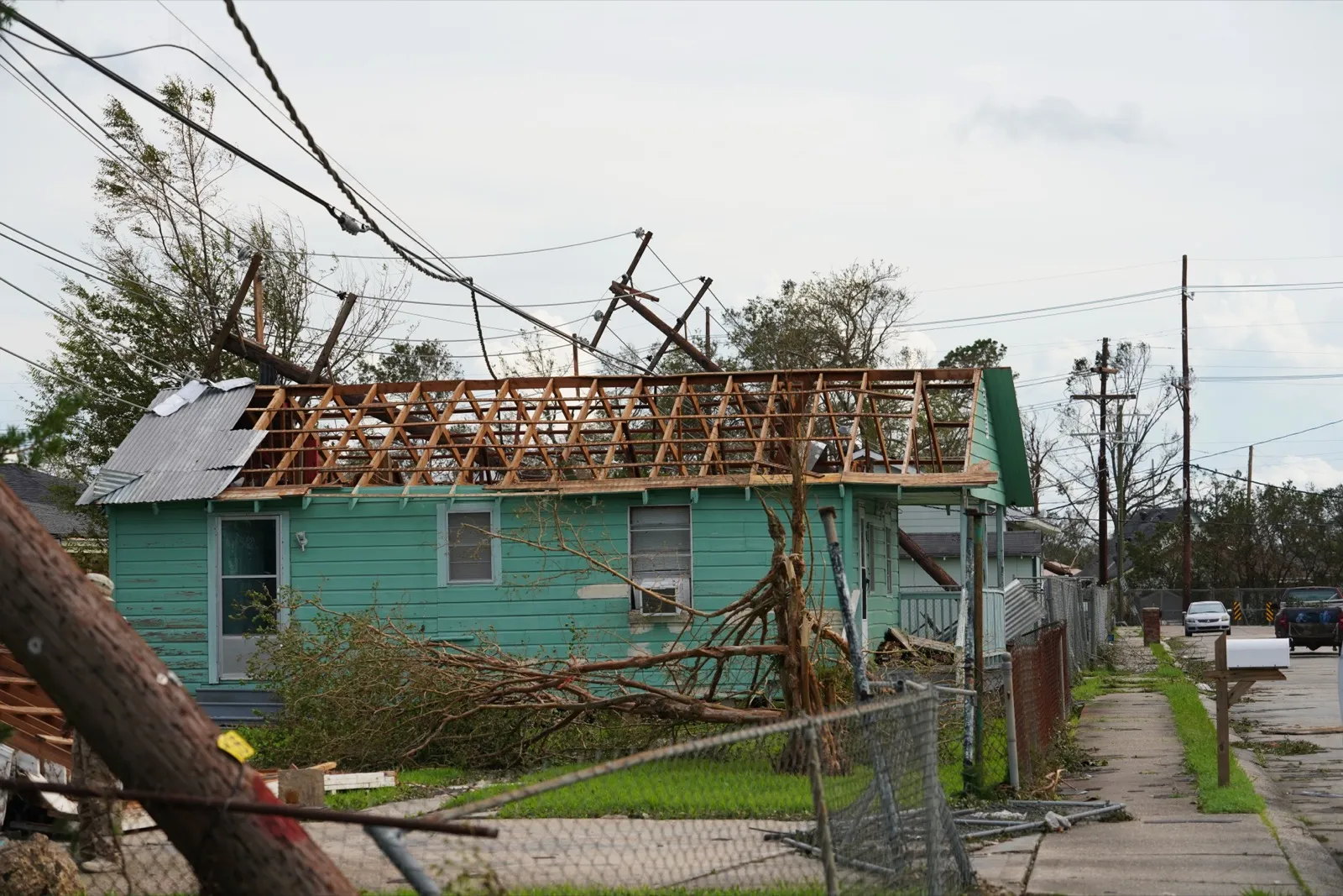 A home in Houma, Louisiana with its roof torn off and power lines down after Hurricane Ida