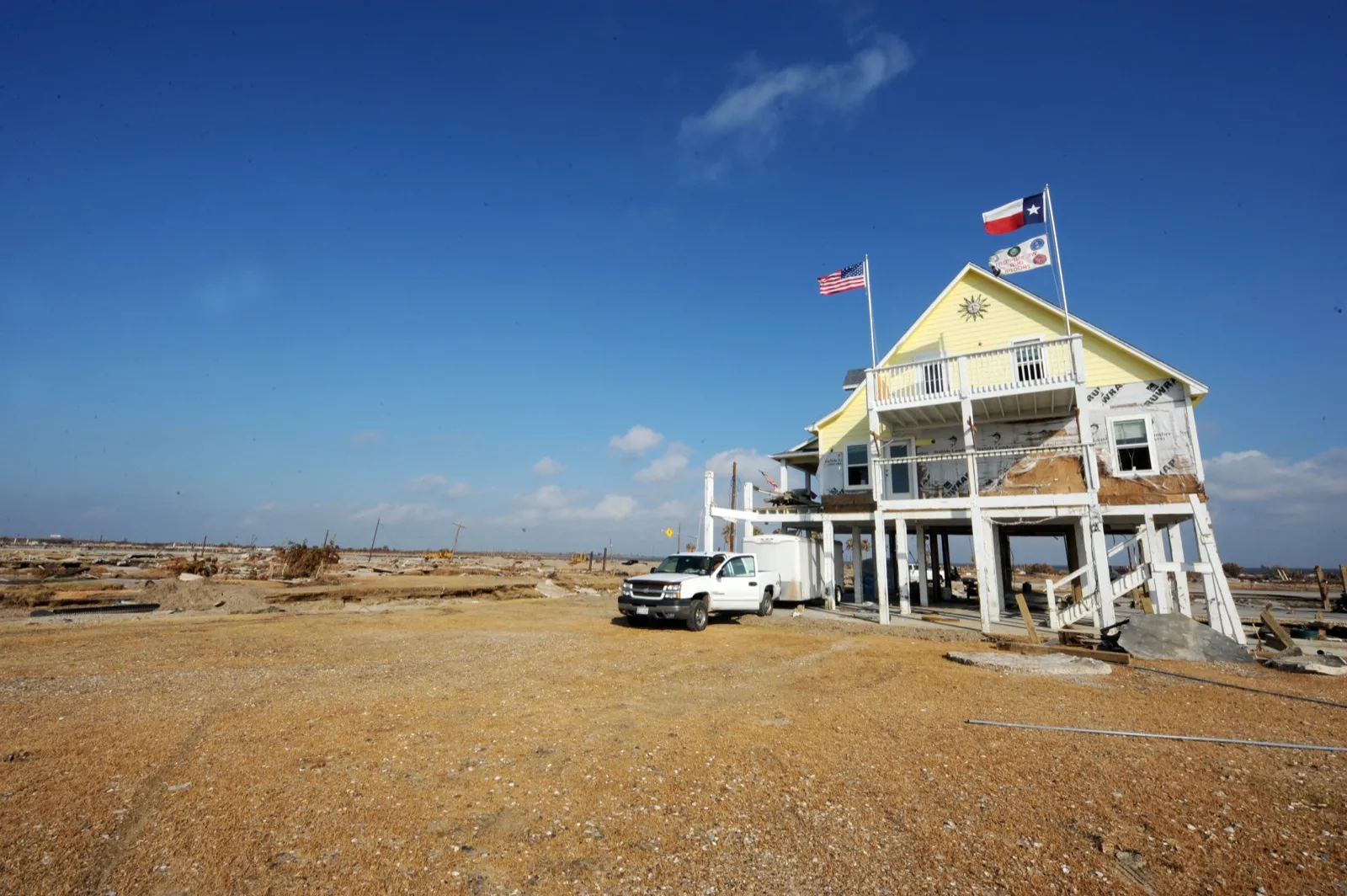 A lone house left standing amid the swept-clean devastation of Gilchrist, Texas after Hurricane Ike