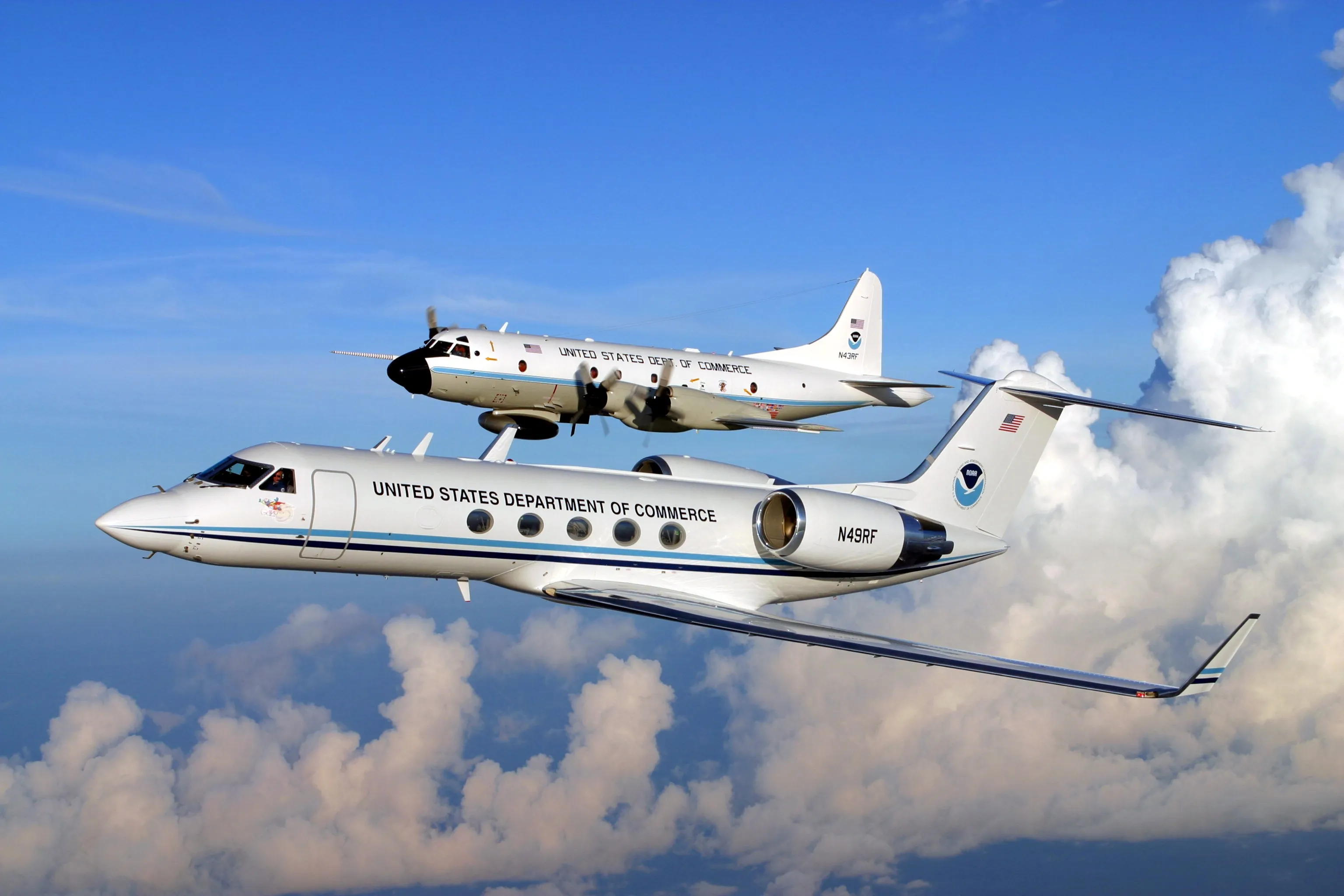 NOAA's Gulfstream IV-SP jet and a WP-3D Orion turboprop fly in formation