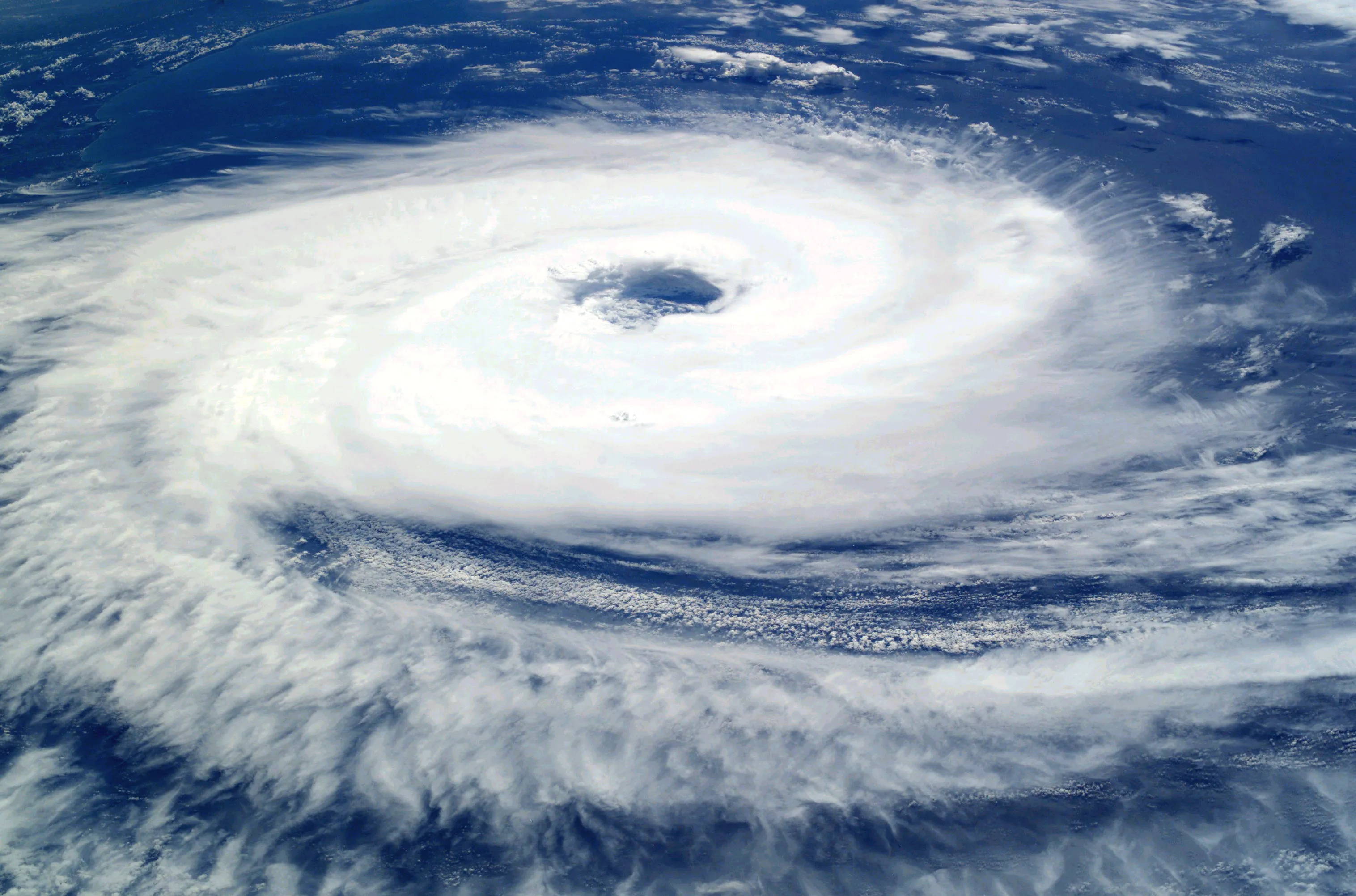 A hurricane seen from space with a clear round eye at the center and spiraling cloud bands