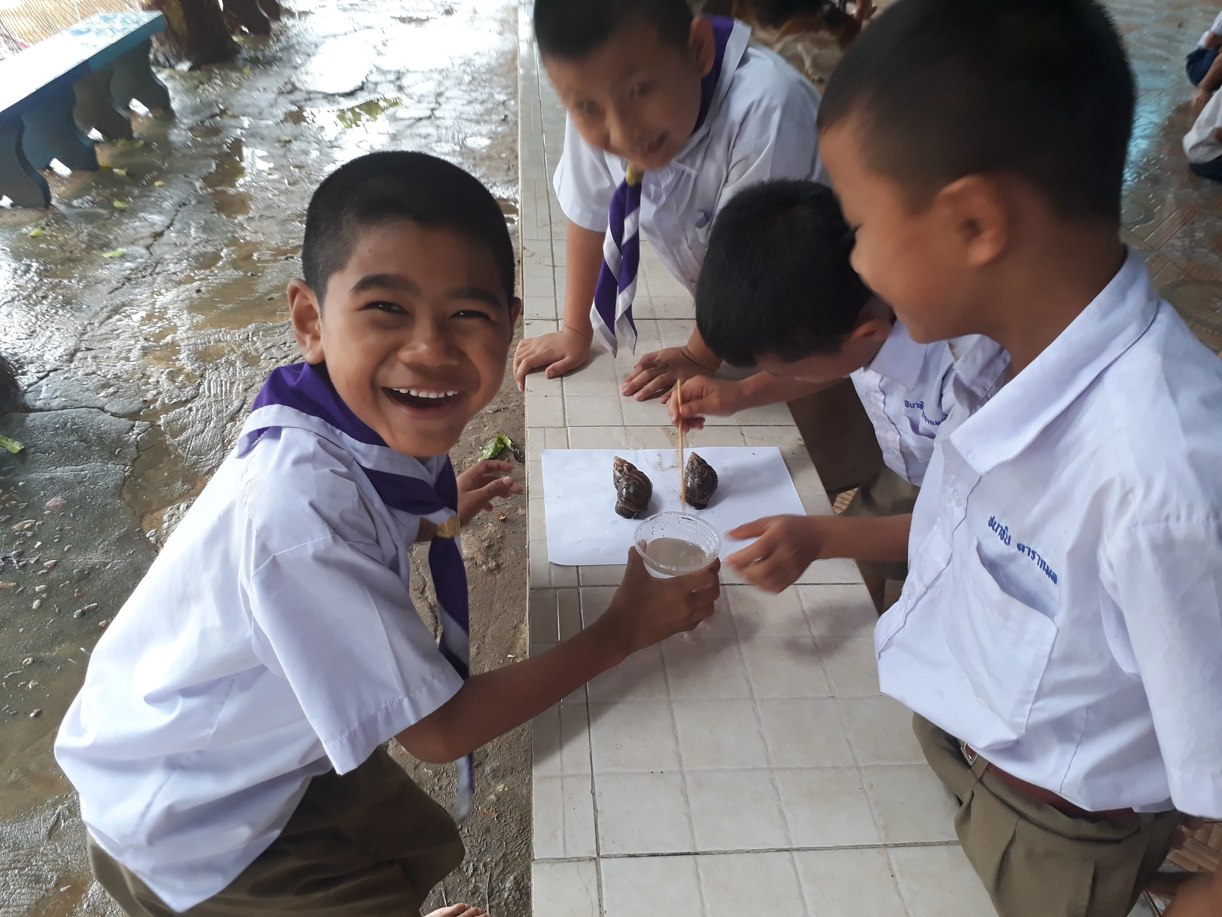 Smiling schoolchildren doing a hands-on science experiment together