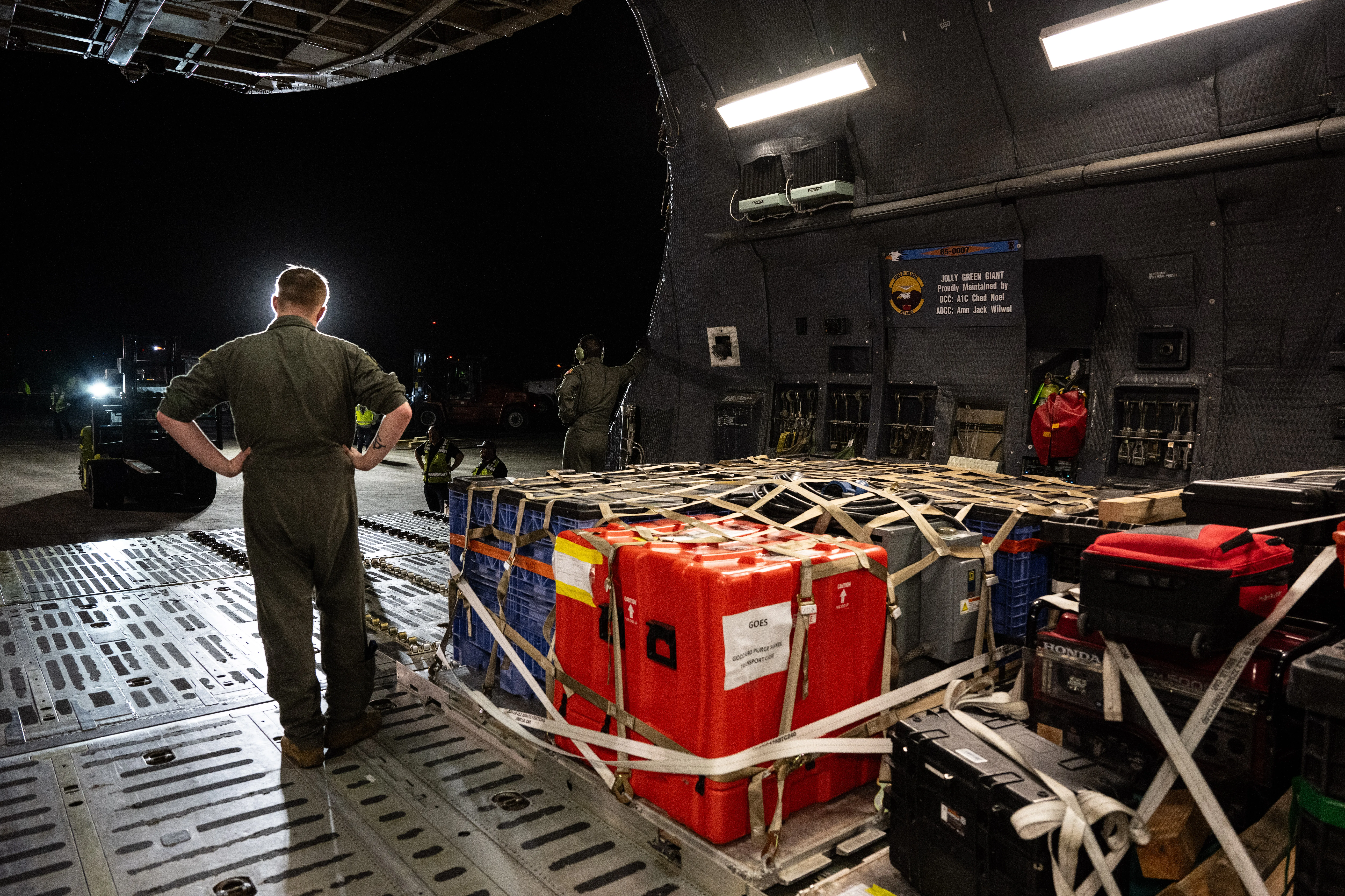 Technicians carefully move a NOAA GOES weather satellite at NASA's Kennedy Space Center