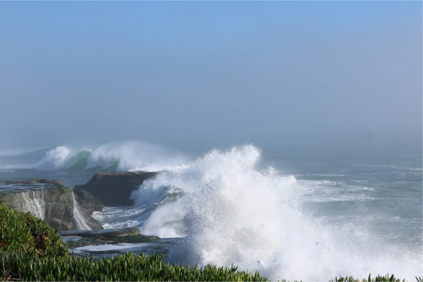 Powerful storm waves crashing onto a rocky coastline