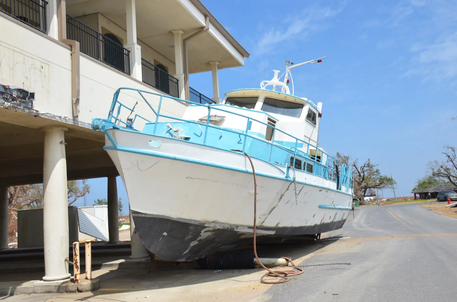A boat deposited against a stilted home in Cameron Parish, Louisiana by Hurricane Laura's storm surge