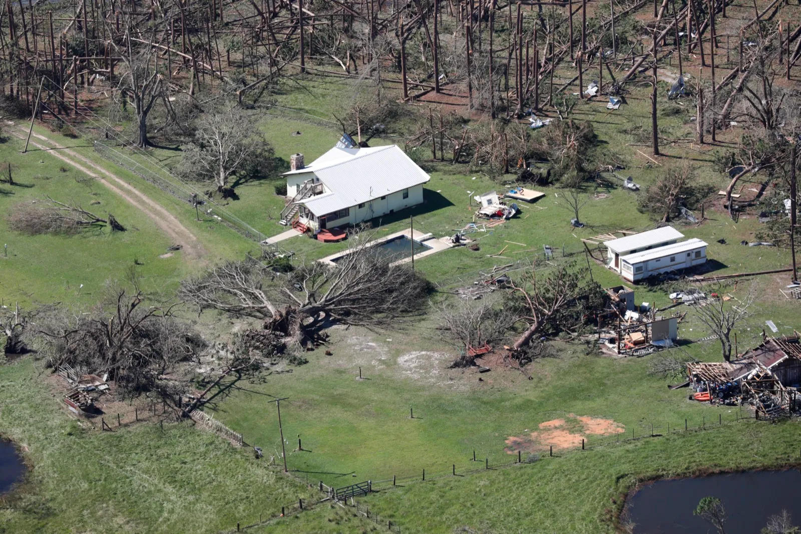 Aerial view of snapped trees and damaged homes across the Florida Panhandle after Hurricane Michael
