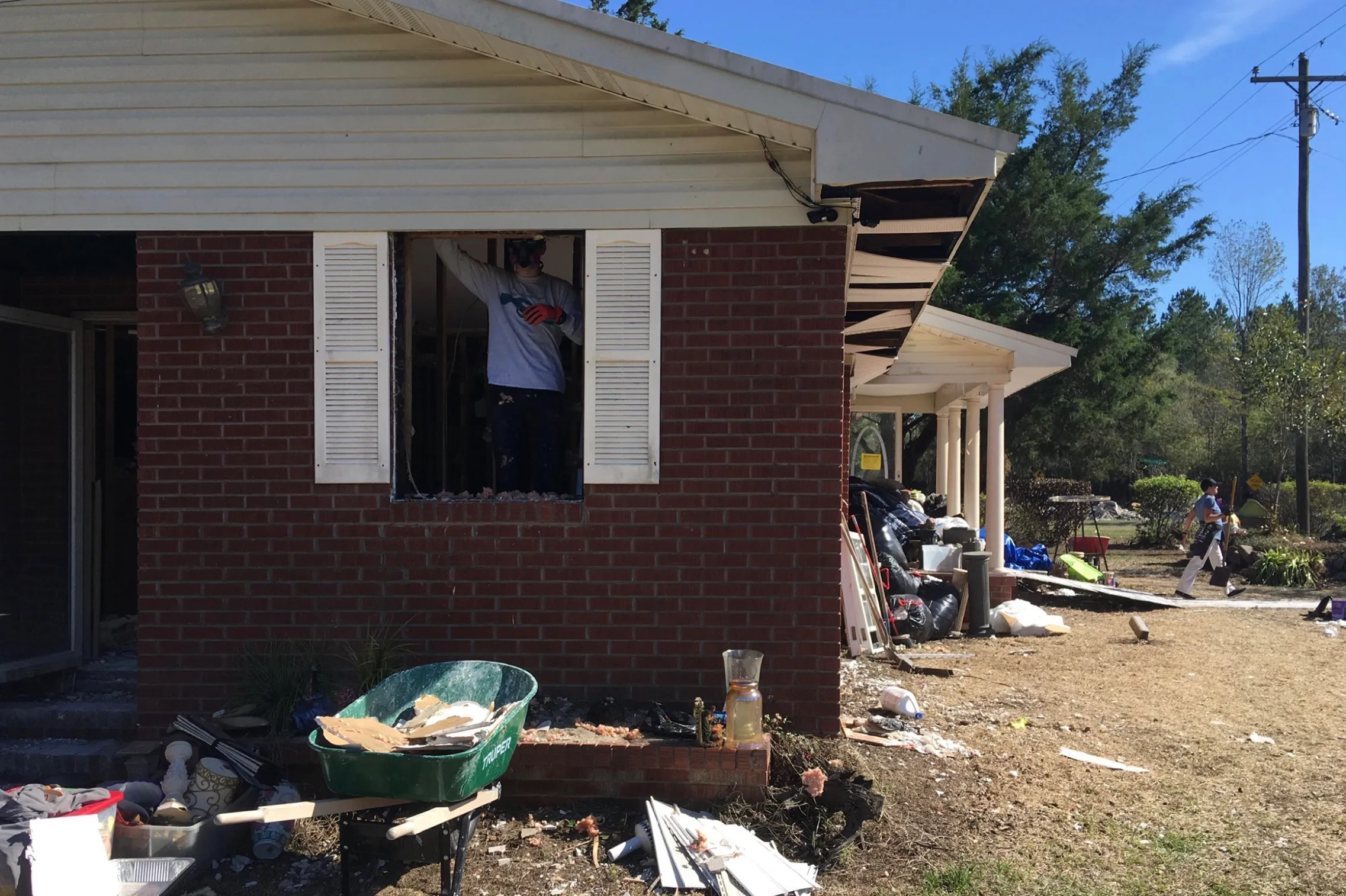 Homeowners gut a flood-damaged house down to the brick and studs during reconstruction