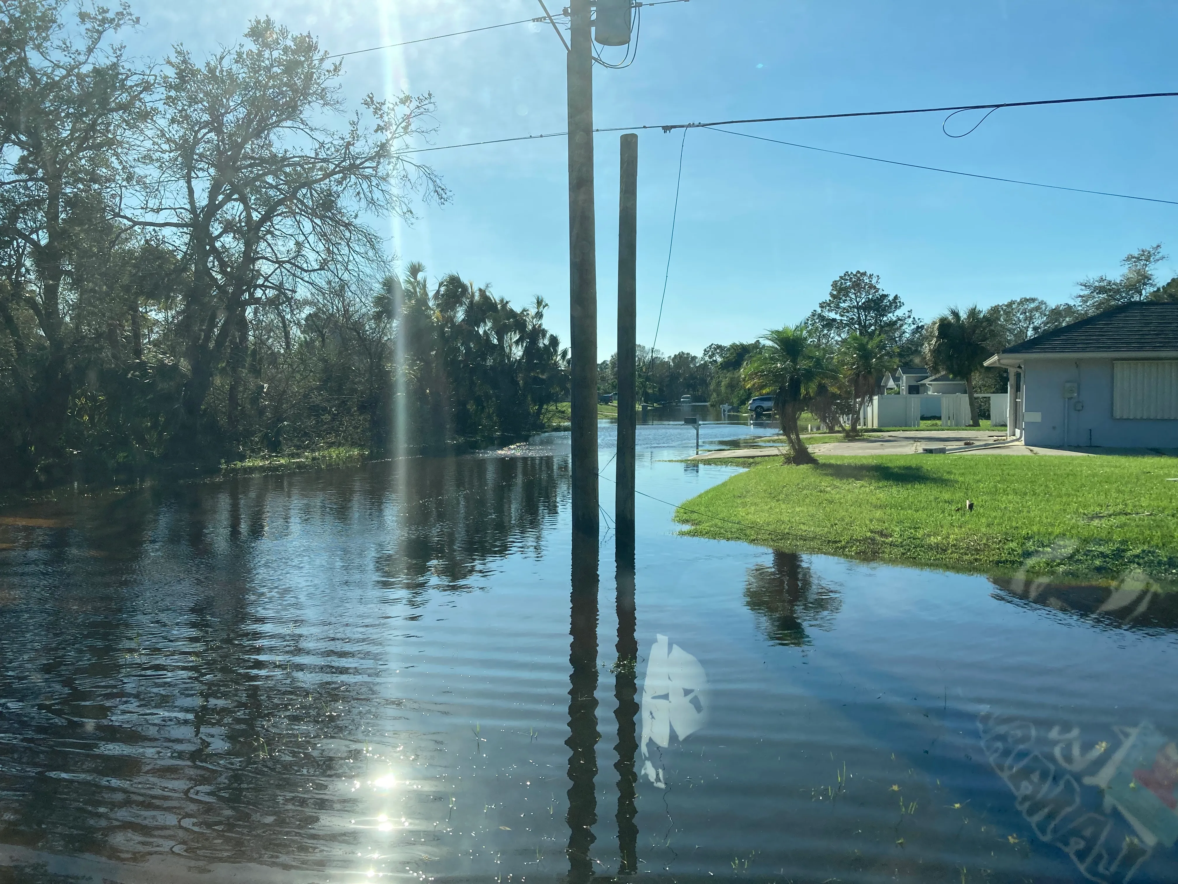 Floodwater fills a residential street after Hurricane Ian, damage that standard homeowners policies exclude