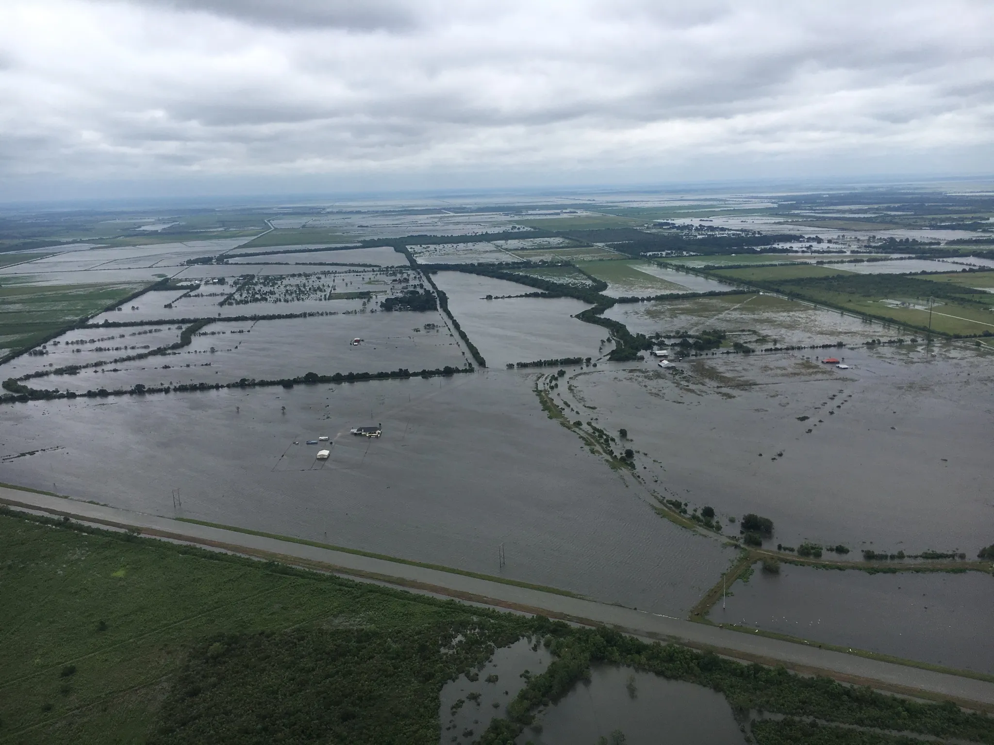 An aerial view of vast inland flooding submerging fields and roads during Hurricane Harvey