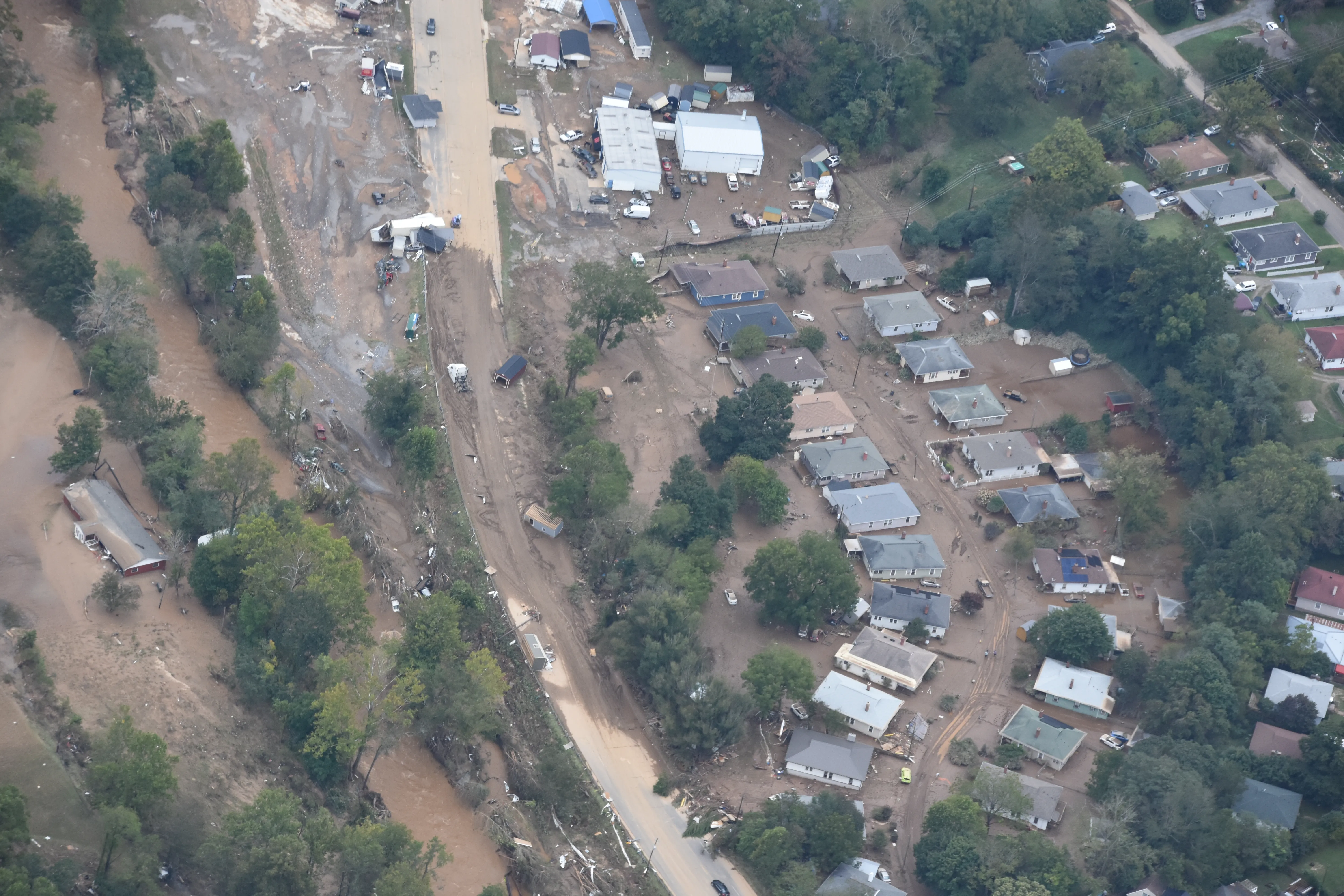 Aerial view of a mountain community in North Carolina buried in mud and debris after catastrophic Helene flooding