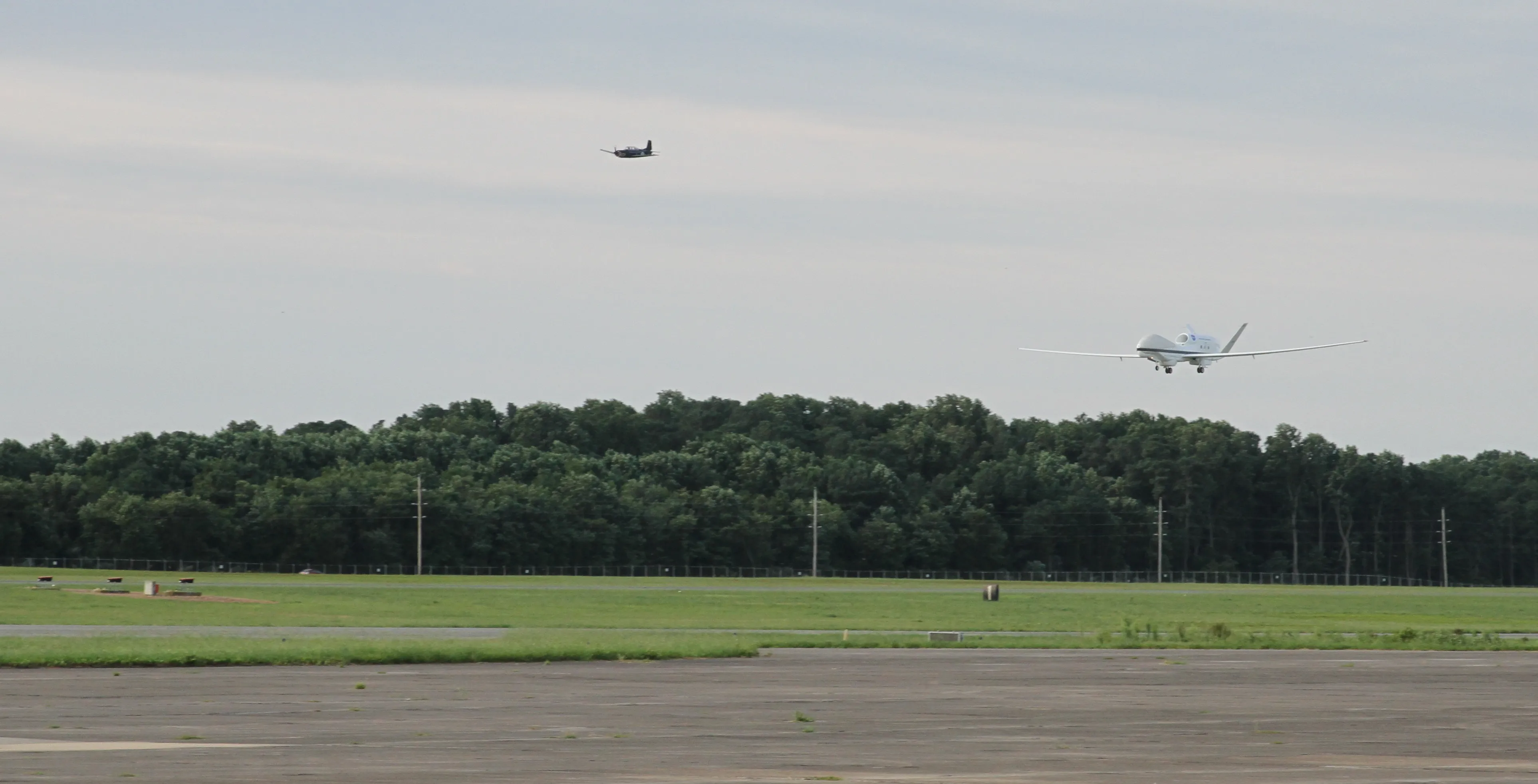 A NASA Global Hawk unmanned aircraft on approach to NASA Wallops with a chase plane behind