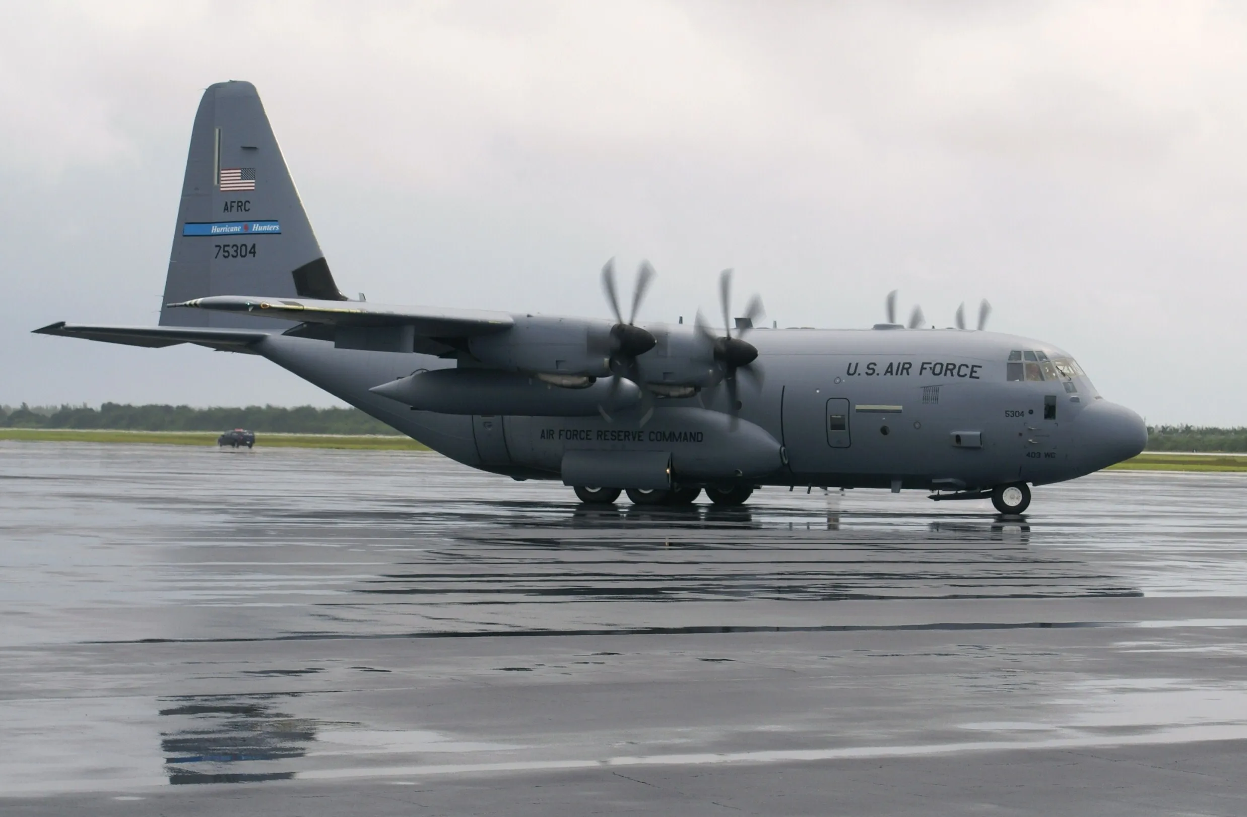 An Air Force Reserve WC-130J Super Hercules "Hurricane Hunter" (tail 75304) on a wet ramp
